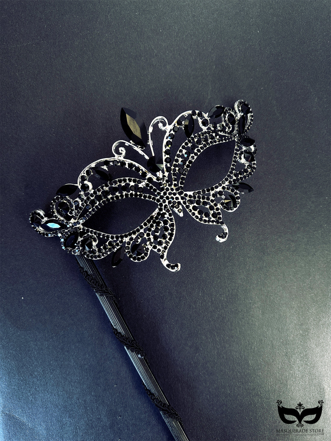 Elegant black masquerade mask on stick with crystal rhinestone jewels