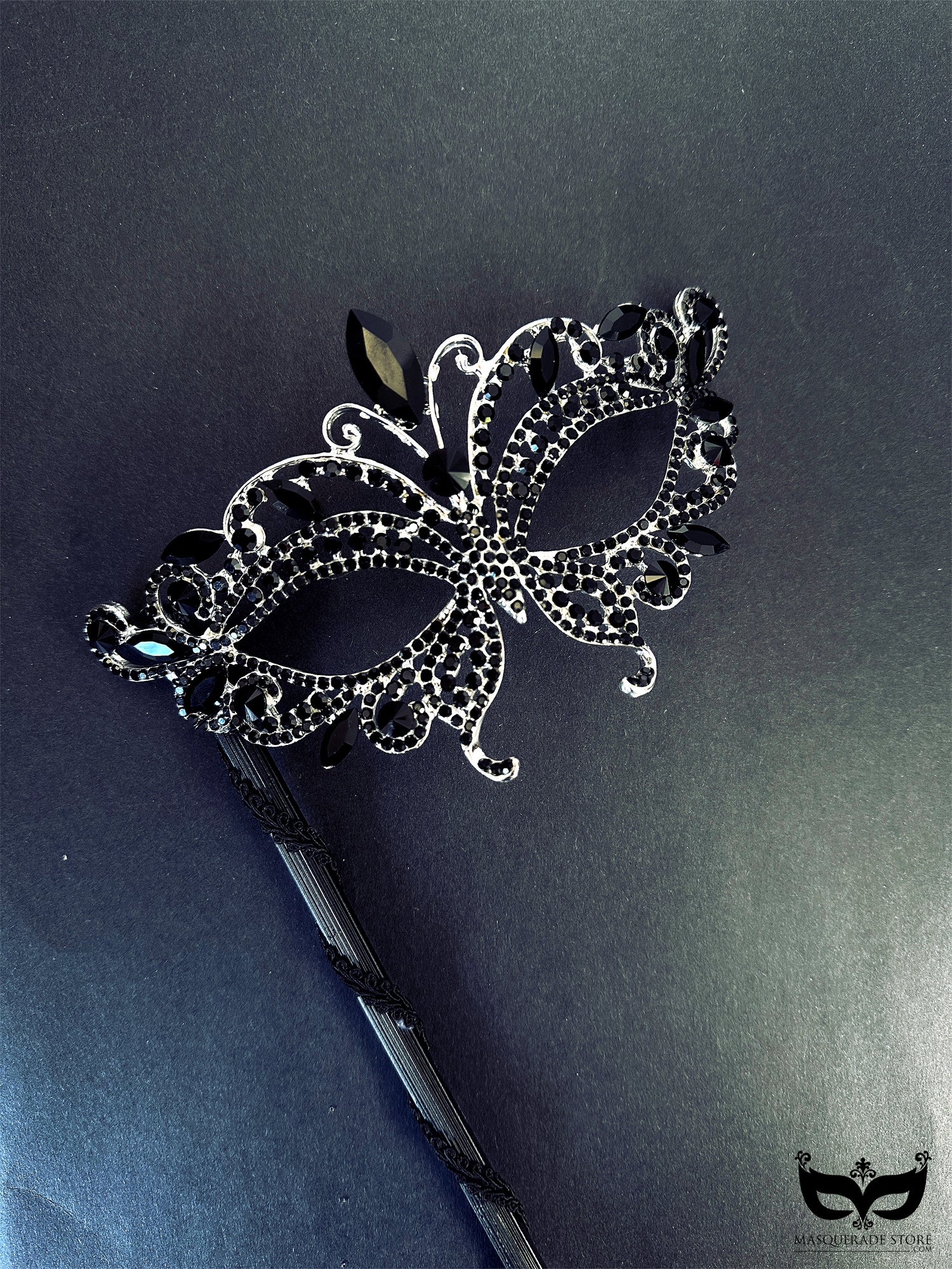 Elegant black masquerade mask on stick with crystal rhinestone jewels