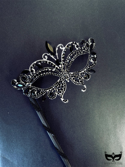 Elegant black masquerade mask on stick with crystal rhinestone jewels
