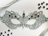 Silver lace masquerade mask with black crystal rhinestones for gala parties and Venetian formal events.