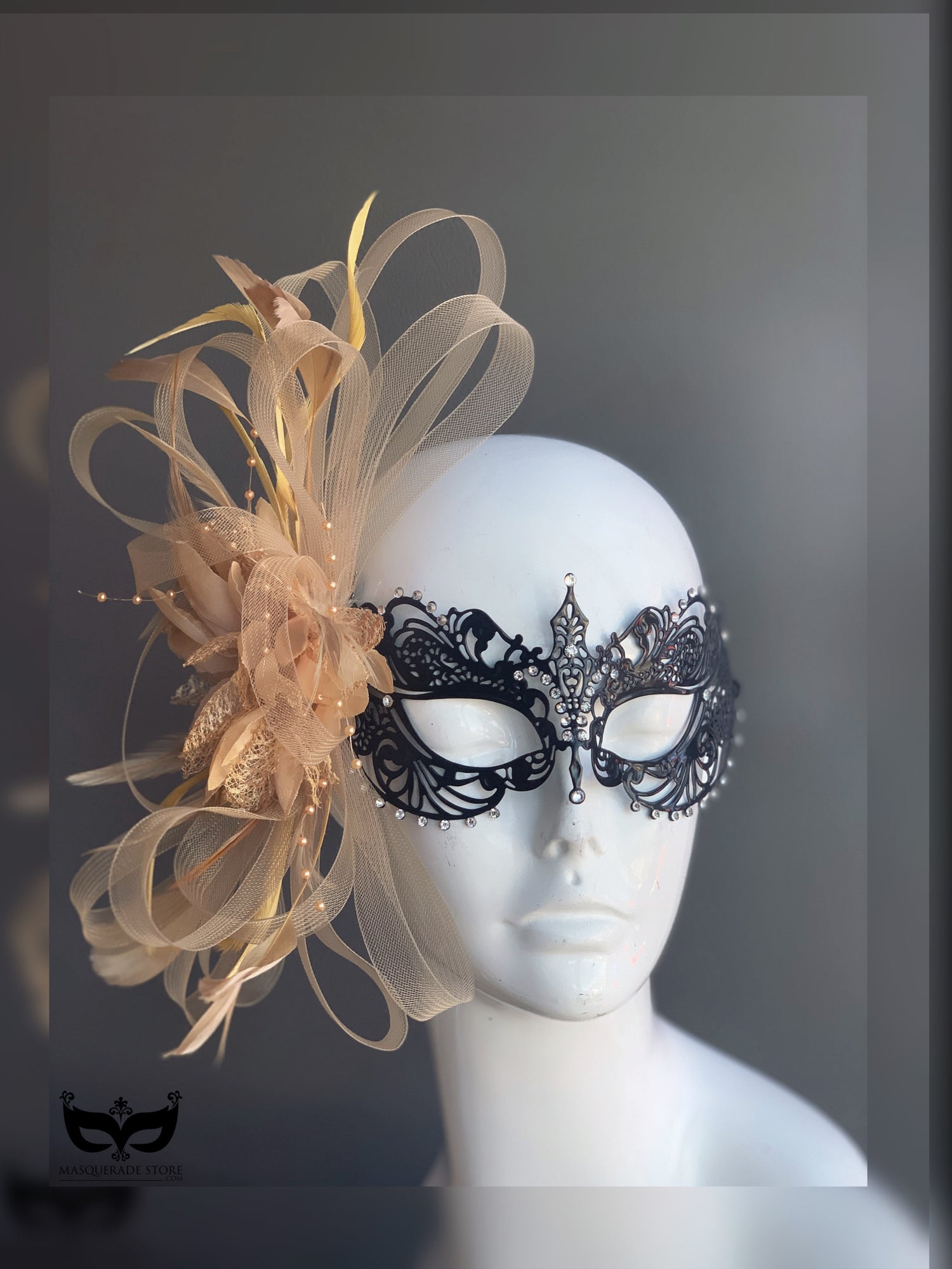 Black filigree masquerade mask with champagne gold feathers, tulle, and crystals for masquerade ball, prom, or Mardi Gras.