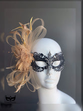 Black filigree masquerade mask with champagne gold feathers, tulle, and crystals for masquerade ball, prom, or Mardi Gras.