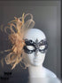 Black filigree masquerade mask with champagne gold feathers, tulle, and crystals for masquerade ball, prom, or Mardi Gras.