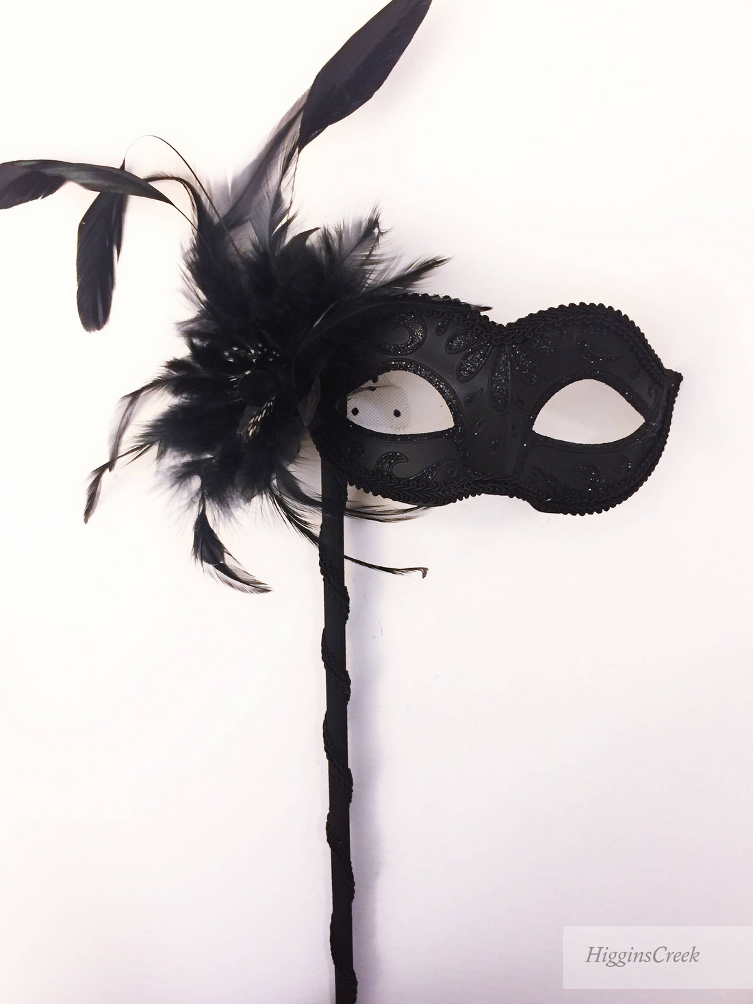 Venetian black filigree masquerade mask on stick with rhinestones.