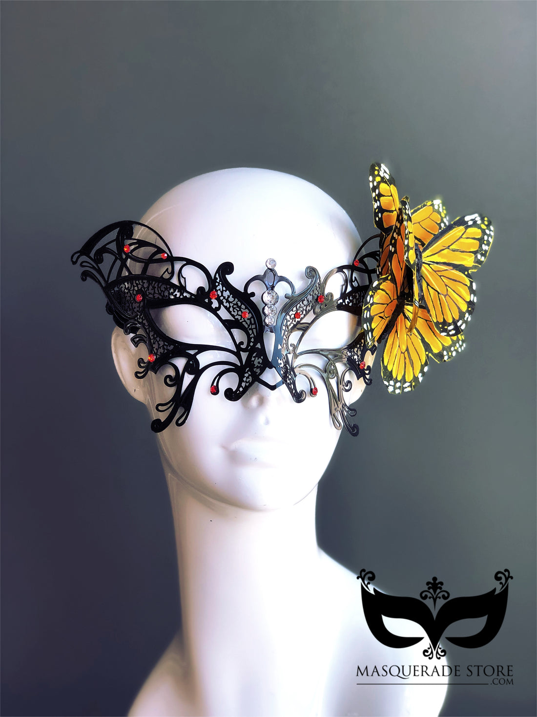 Black filigree masquerade mask with rhinestones and yellow butterfly accent, perfect for costumes and balls.