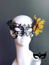 Black filigree masquerade mask with rhinestones and yellow butterfly accent, perfect for costumes and balls.