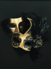 Black and gold masquerade couples masks, one with feathers and glitter floral detailing, perfect for Venetian balls, Mardi Gras, and prom.