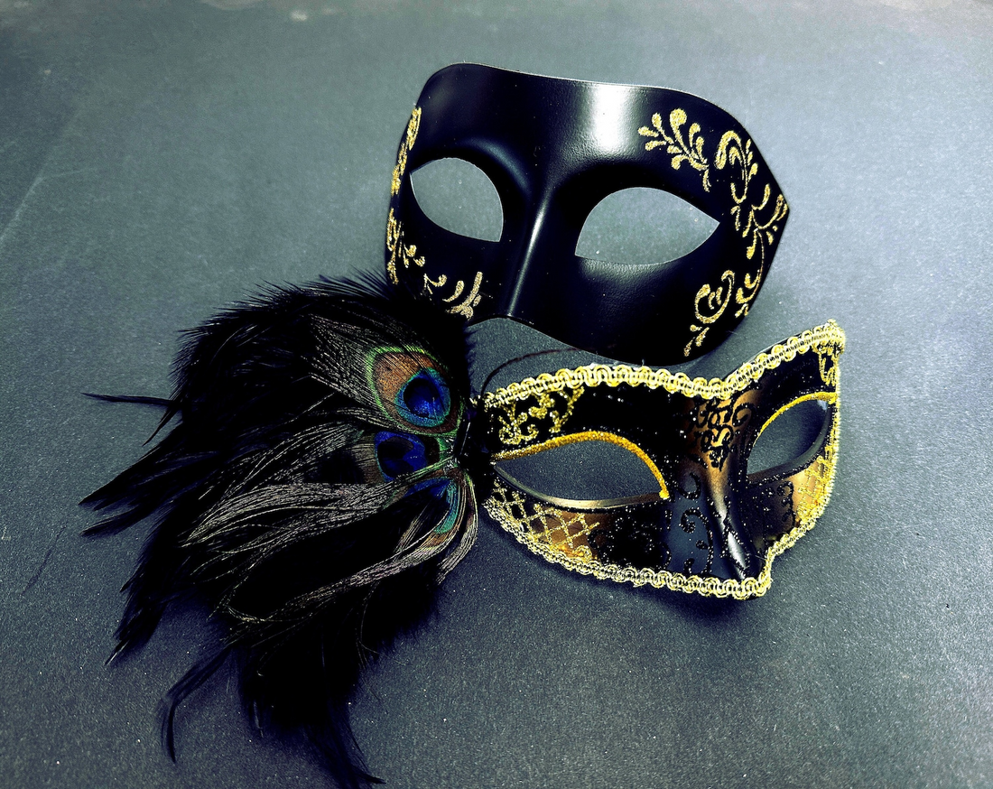 Black and gold couples masquerade masks with peacock feathers, glitter accents, and Venetian details.