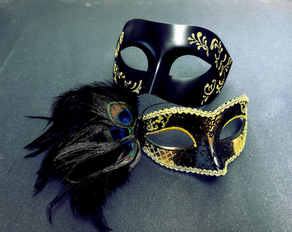 Black and gold couples masquerade masks with peacock feathers, glitter accents, and Venetian details.