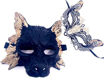Elegant black and gold couples masquerade mask set with bold men’s mask and delicate filigree women’s mask.