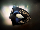Elegant black half-face masquerade mask with floral gold accents