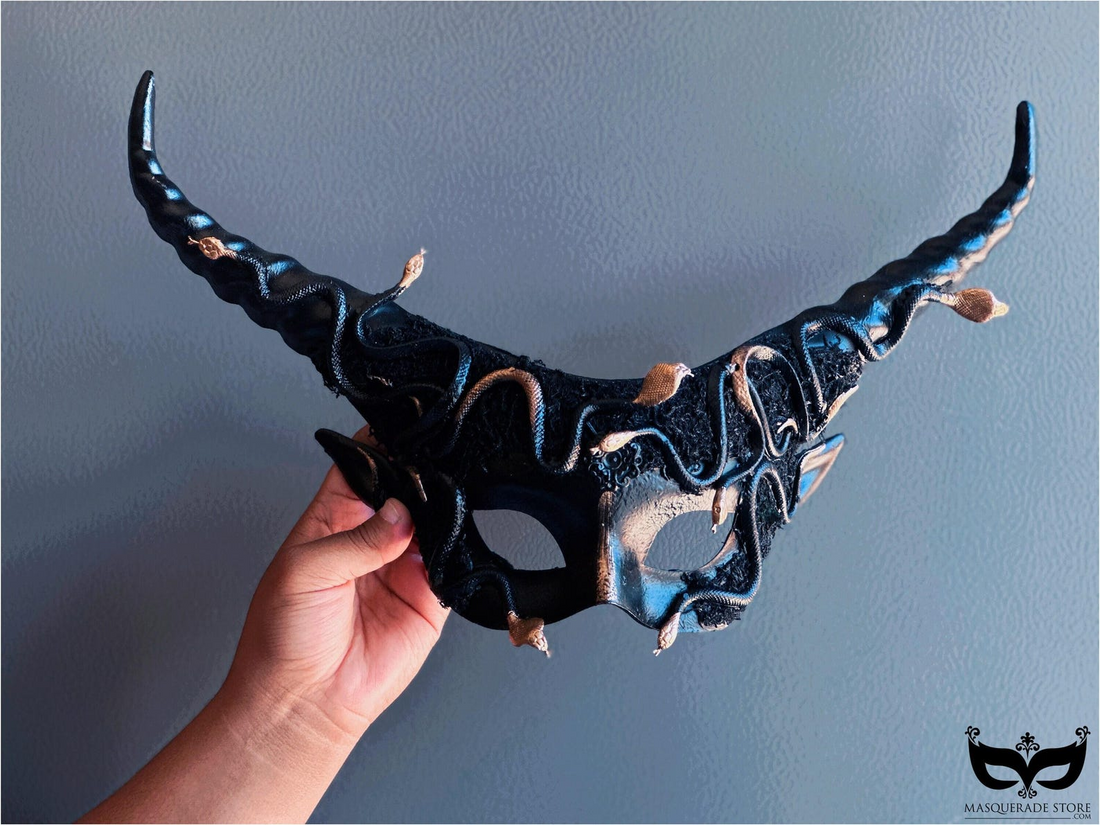 Black horn masquerade mask entwined with gold snakes, Medusa-inspired for gothic fantasy and Halloween.