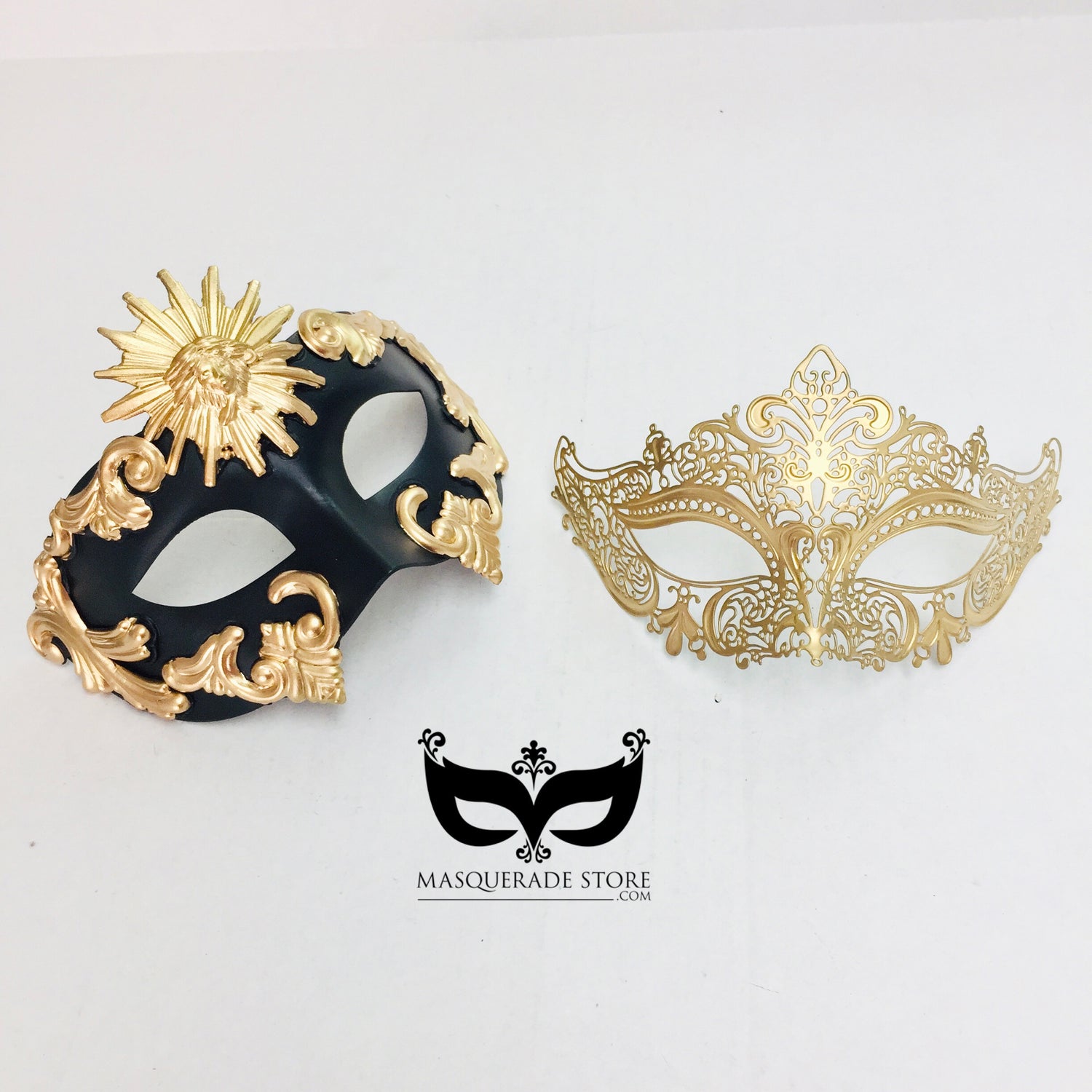 Black and gold couples masquerade mask set featuring a men’s baroque sun mask and a women’s golden filigree mask.