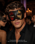 Black men’s casino masquerade mask with distressed red and gold harlequin diamond eye accents.
