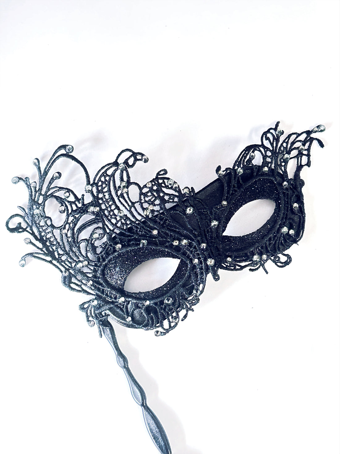 Black lace masquerade mask with rhinestones and stick handle for masquerade ball or prom.