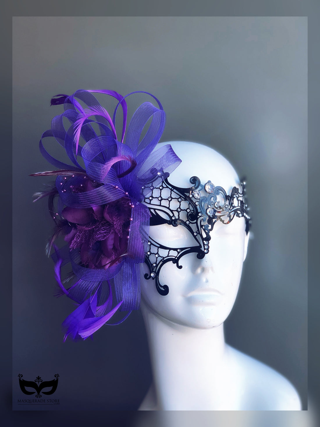 Black lace masquerade mask with purple tulle, feathers, rhinestones, and floral accents for women.