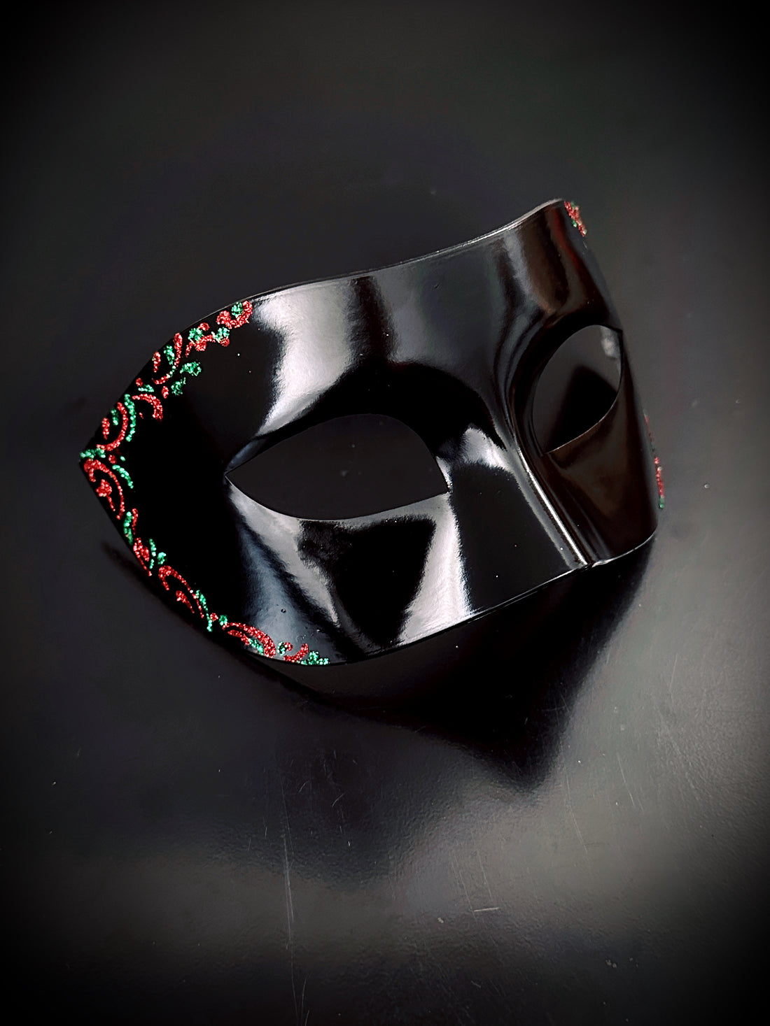 Minimalist black mask with festive red and green floral trim