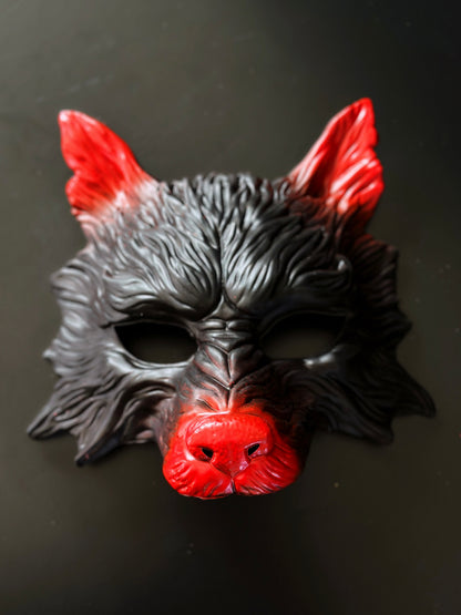 Black and red wolf masquerade mask with sculpted details for costume and cosplay events.