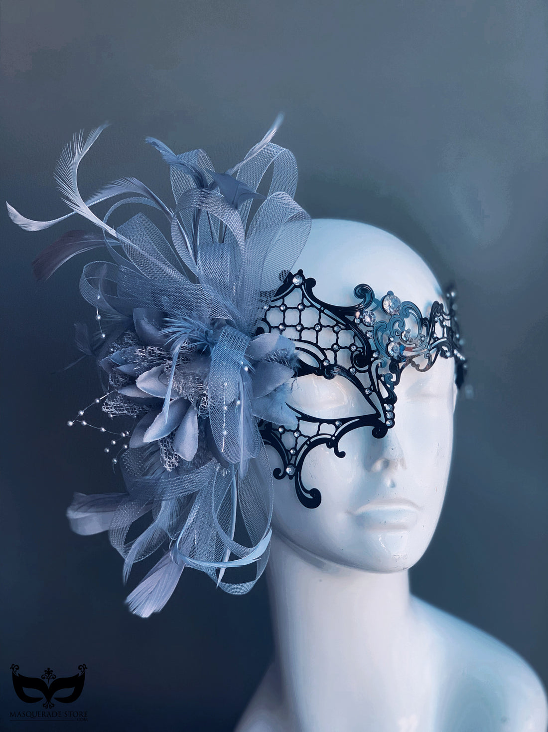 Black masquerade mask with silver tulle, feathers, rhinestones, and lace filigree design for women.