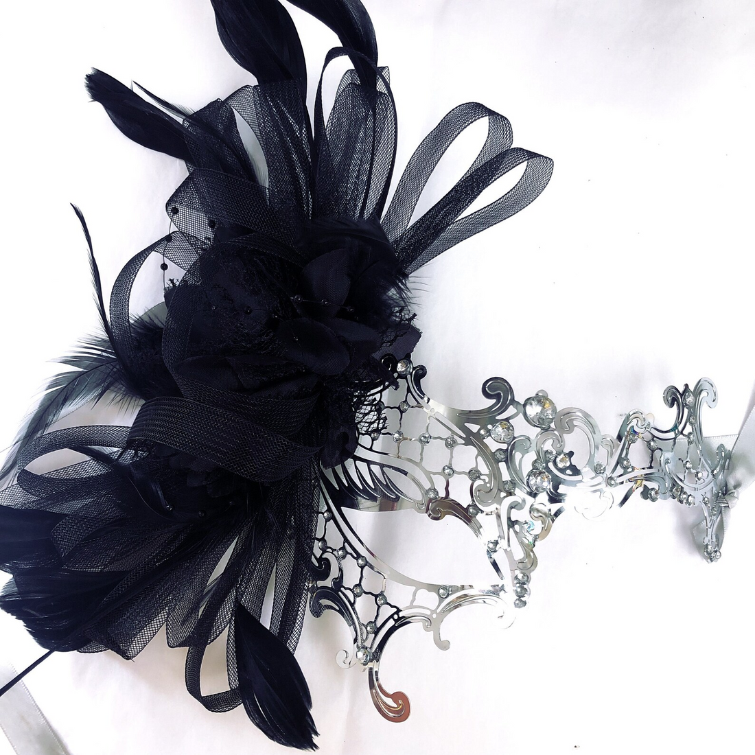 Black and silver women masquerade masks with feathers, rhinestones, and elegant Venetian details.