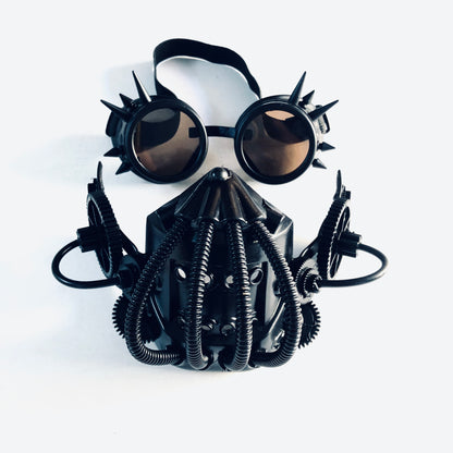 Industrial-style black steampunk mask with tubing and goggles featuring spiked rims