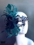 Black lace masquerade mask with teal tulle, feathers, and rhinestone accents for women.