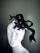 Elegant black and white fascinator hat with oversized bow and lace applique, designed for weddings, derby fashion, and tea parties.
