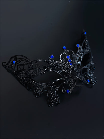 Black filigree masquerade mask with sapphire blue rhinestones, ideal for women attending Venetian masquerade balls, Mardi Gras, and Halloween parties.