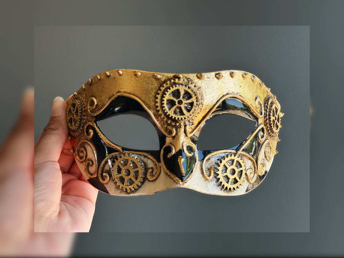 Steampunk masquerade mask in gold, black, and white with gear accents, perfect for Halloween, cosplay, or Victorian-themed masquerade balls.