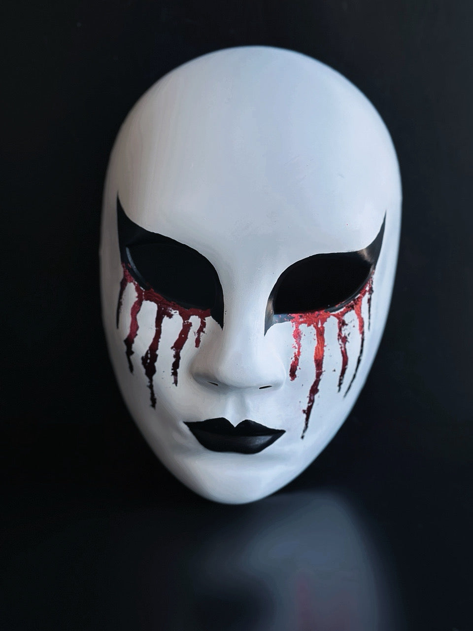 Bloodveil Hollow white full-face Halloween mask with black eye details, black lips, and red drip accents for gothic costume styling.