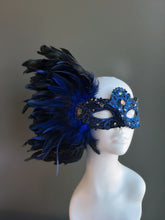 Blue feather mask with side plume and glittering gems for Mardi Gras or masquerade parties