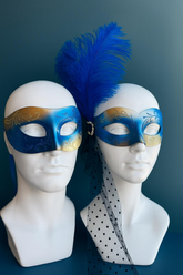Blue and gold couples masquerade masks, men’s simple design, women’s mask with feather and dotted veil.