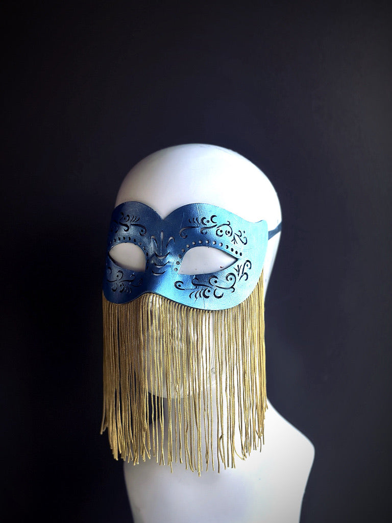 Blue party mask with gold dangling fringe and black filigree for burlesque or masquerade night