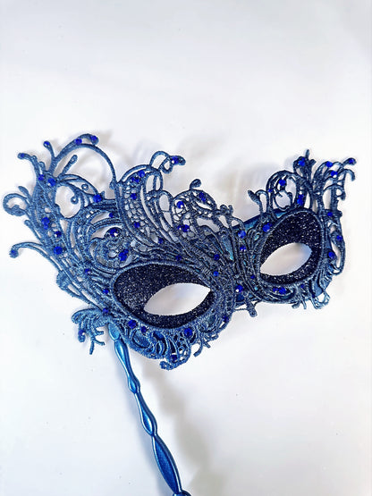 Blue lace masquerade mask with rhinestones and stick handle for masquerade ball or prom.