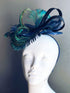 Navy blue feathered fascinator featuring peacock plumes and sculptural loops for formal fashion or parties