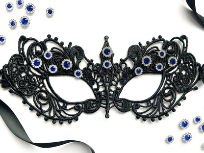 Black lace masquerade mask with sapphire blue rhinestones for gala parties and Venetian formal events.