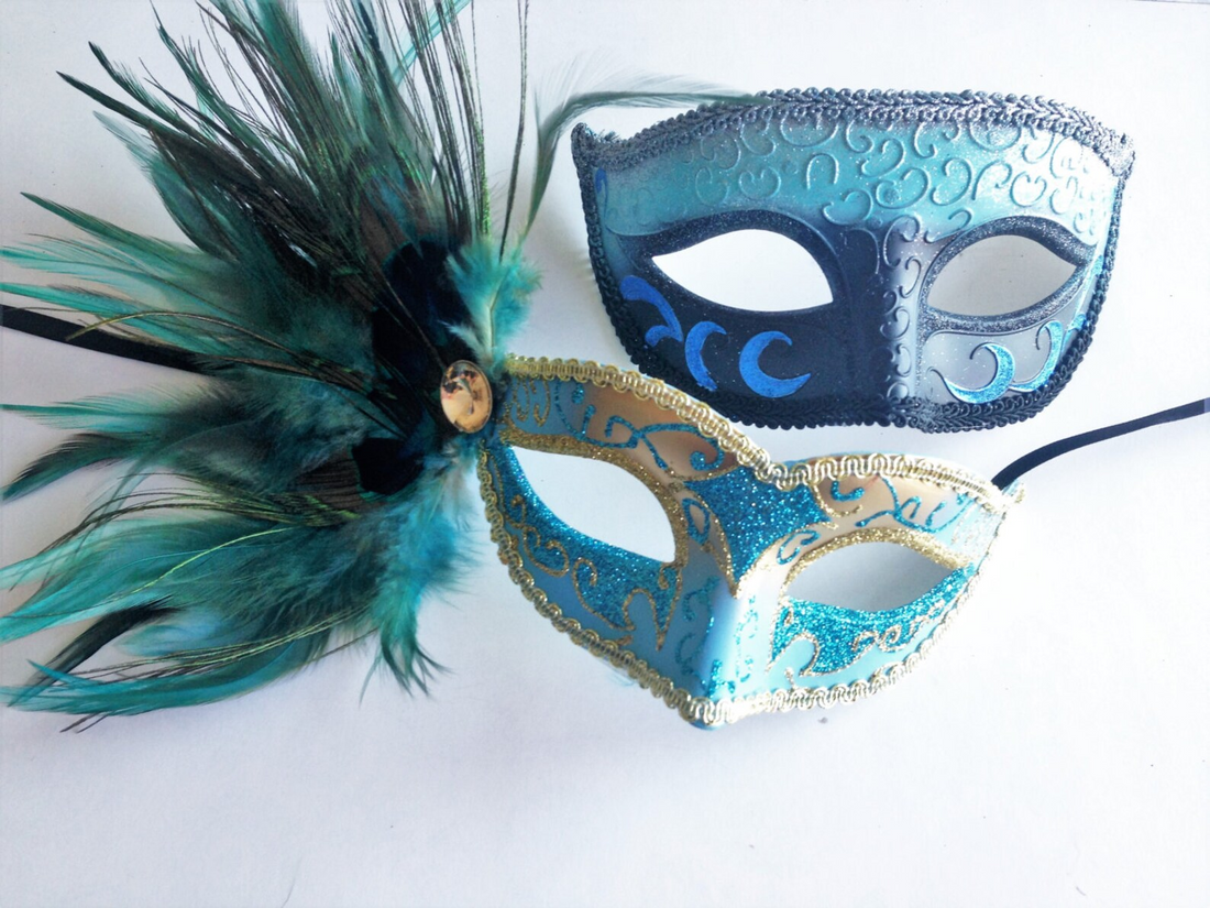 Blue and teal couples masquerade mask set with men’s crescent moon mask and women’s teal feather glitter mask.