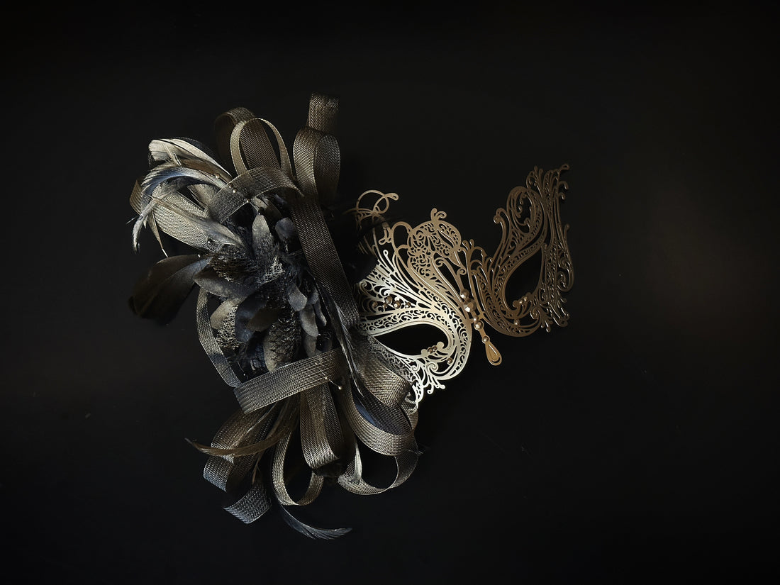 Gold and brown masquerade mask with filigree metal, tulle ribbon, and feathers, designed for proms and costume balls