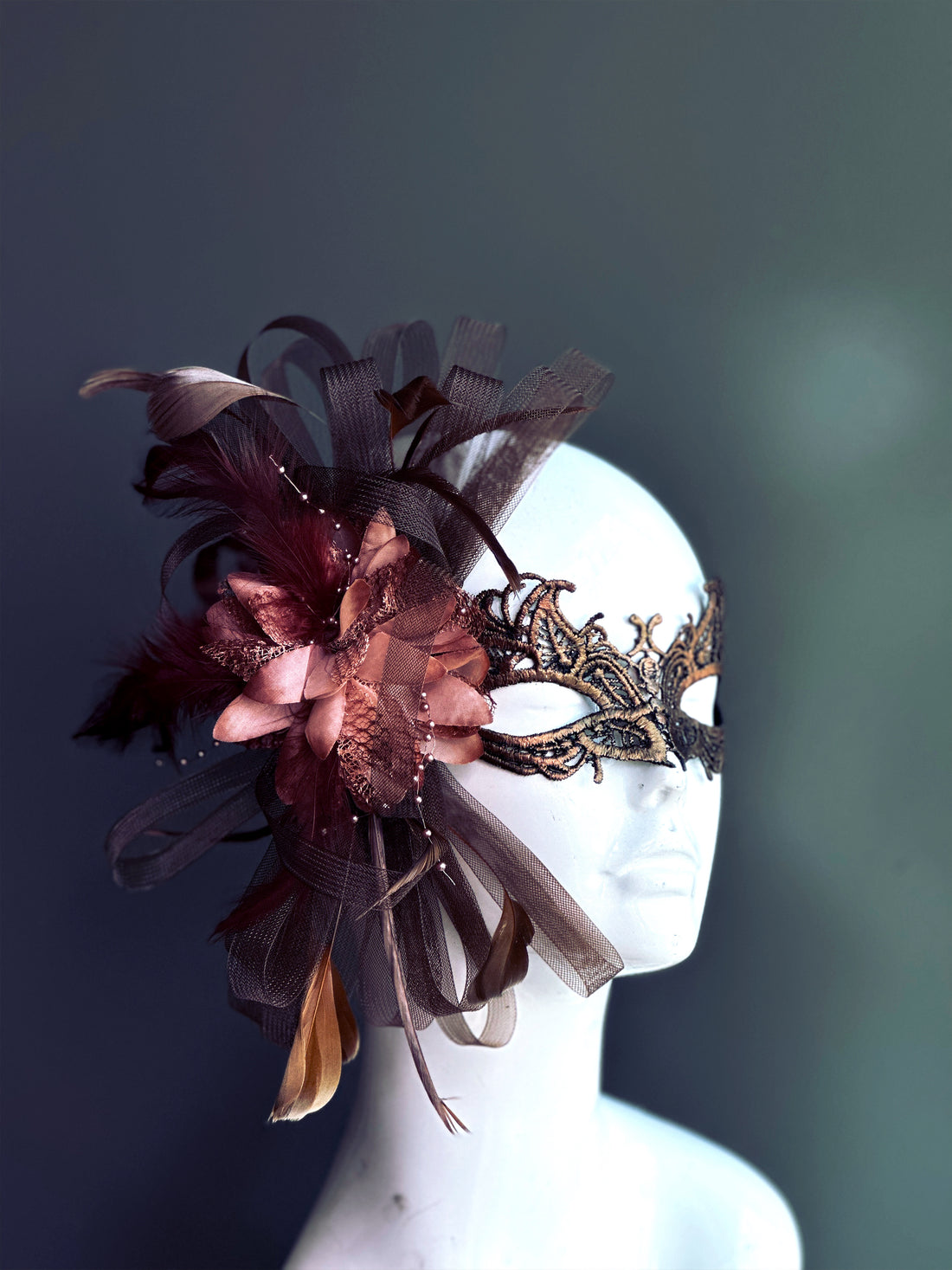 Burgundy and bronze lace masquerade mask with floral, feather, and tulle accents for prom, masquerade, or Halloween costumes.