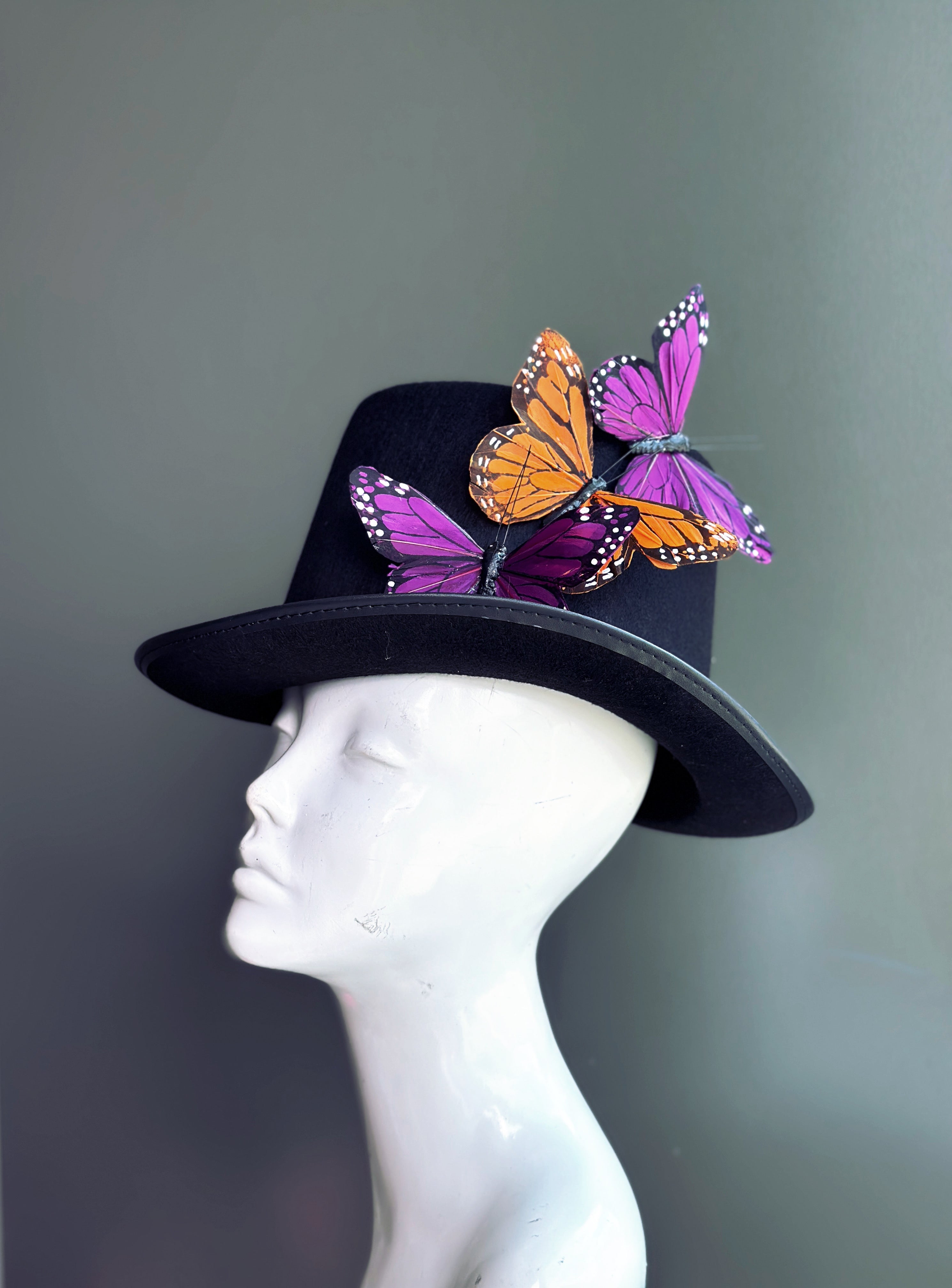 Black top hat with orange monarch and purple butterflies, whimsical fantasy costume accessory