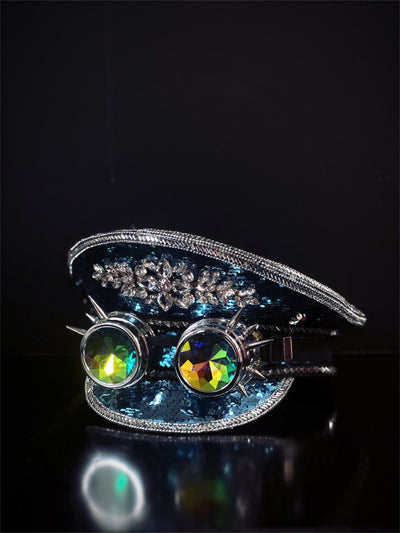 Blue sequin captain hat with silver trim and silver spiked goggles.