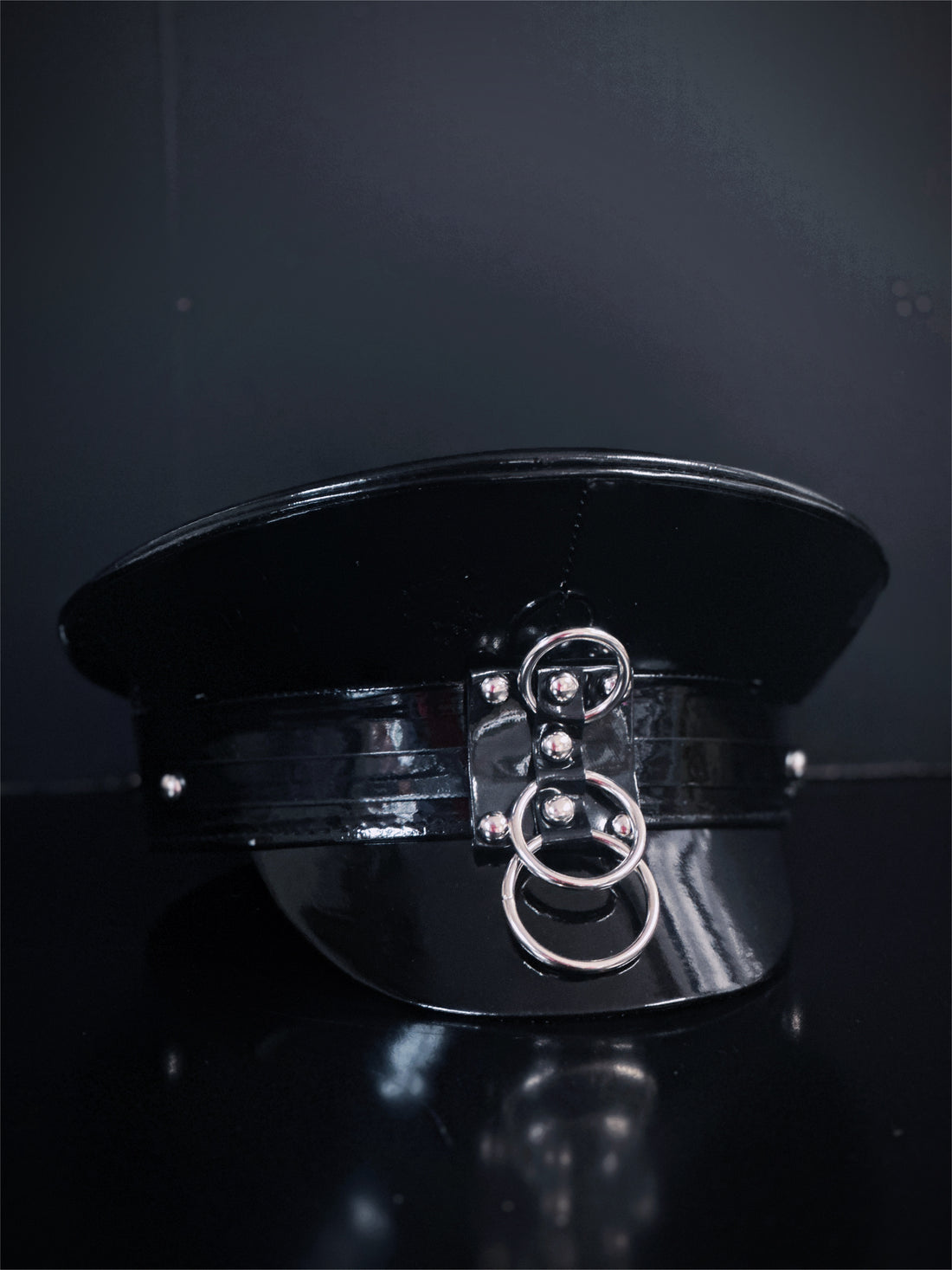 Black captain hat with silver o-rings.