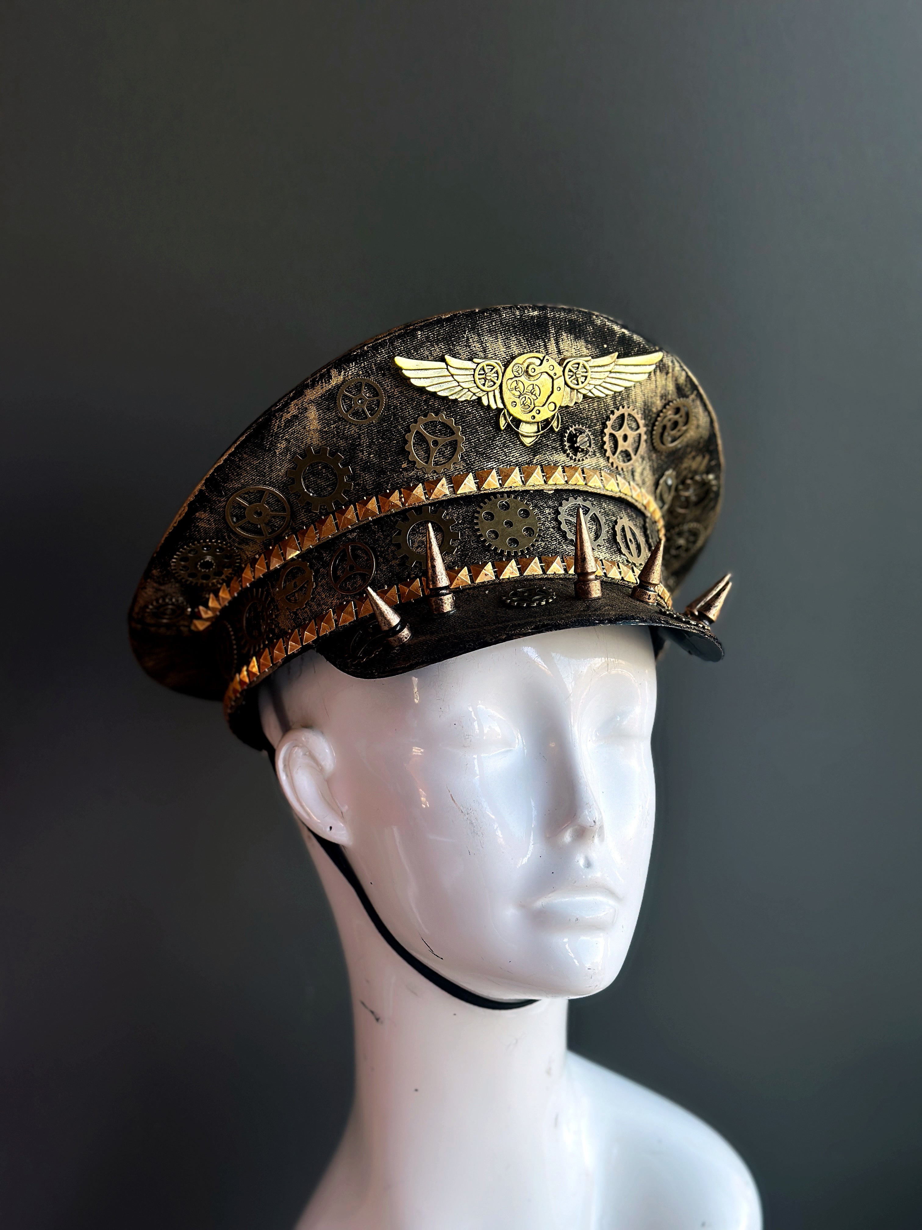 Steampunk captains hat in gold with cogs, gears, and spikes.
