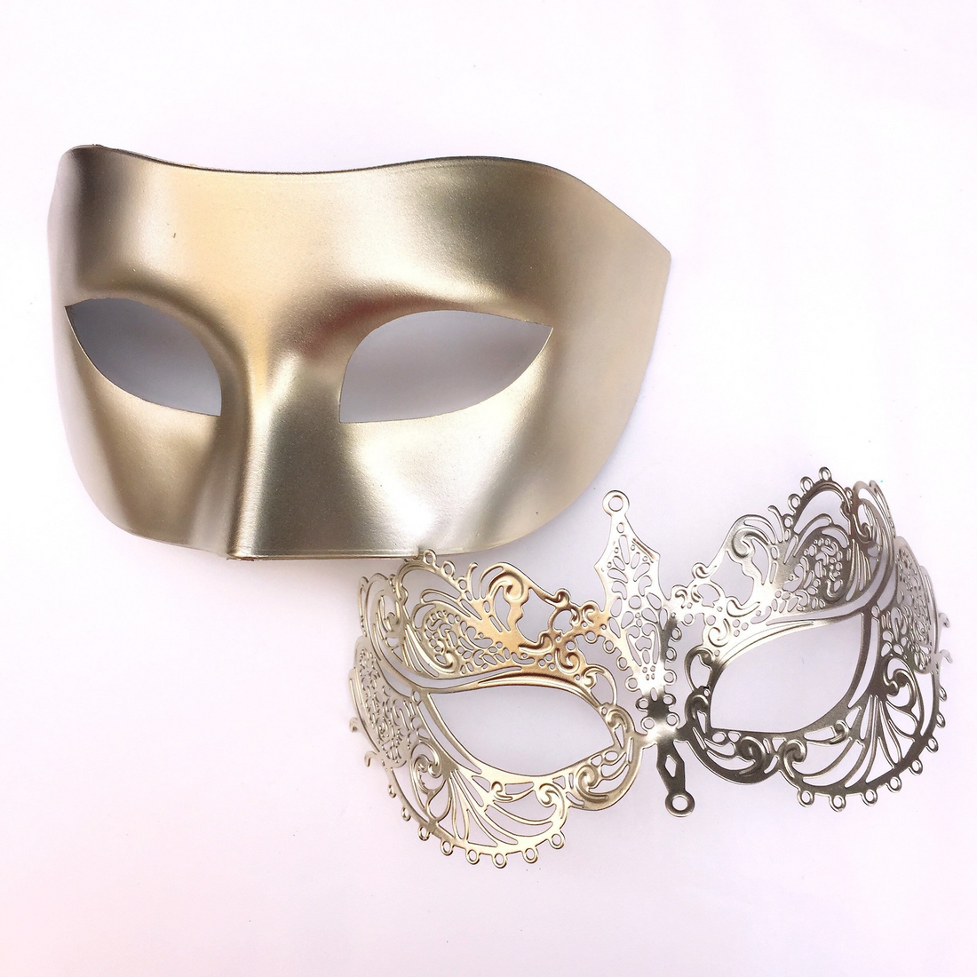 Champagne couples masquerade masks with metallic men’s mask and elegant filigree women’s mask for weddings and masquerade balls.
