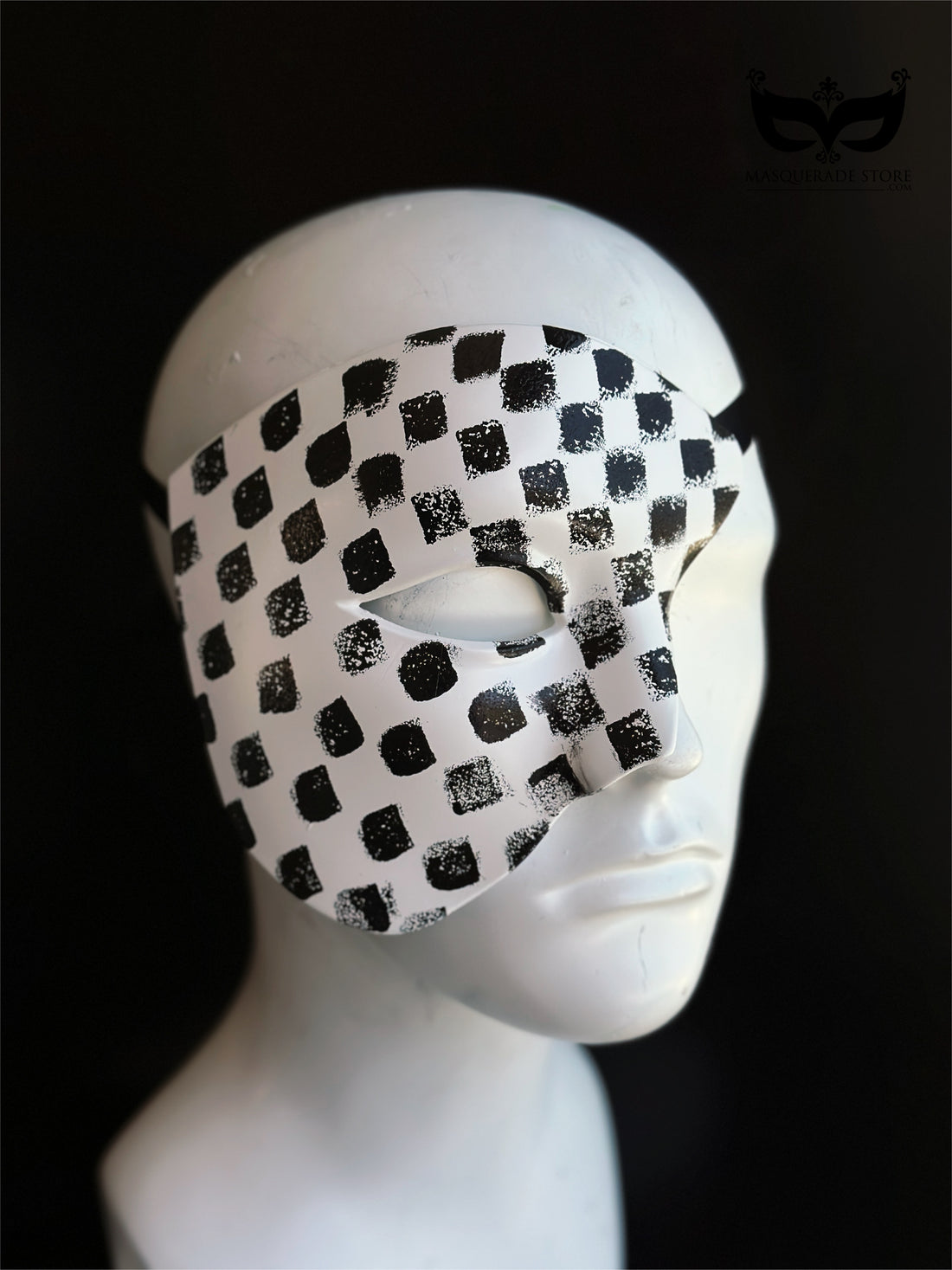 Checkmate Phantom black and white half mask with distressed checker pattern, asymmetrical face coverage, sculpted eye opening, and theatrical styling.