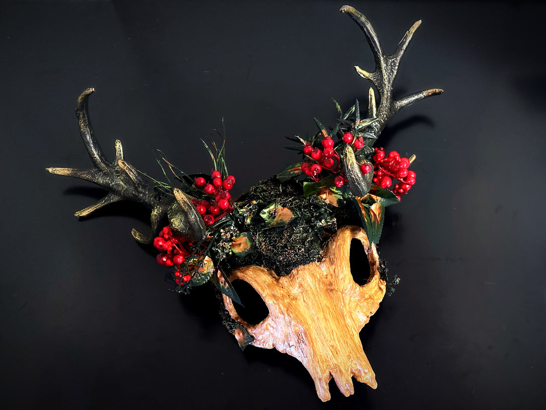 Christmas woodland skull antler headdress with moss, red berries, and painted deer skull for Yule or Krampus cosplay