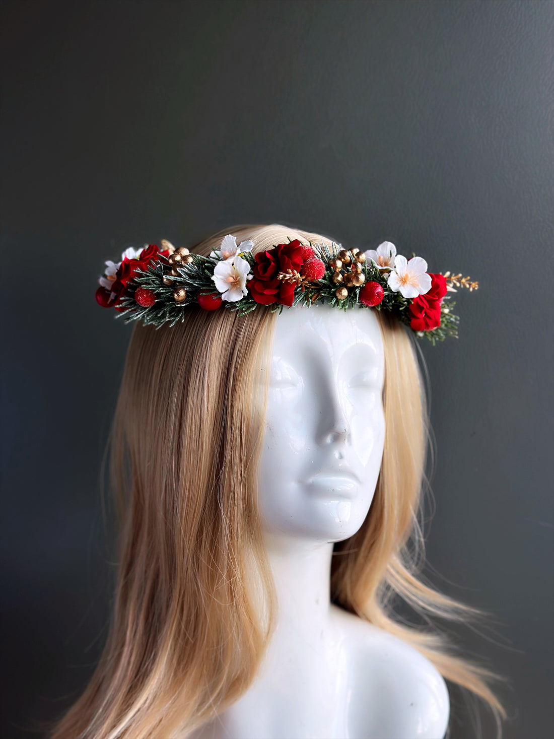 Christmas floral crown headband with red roses, white blossoms, frosted greenery, berries, and gold accents for weddings and holiday parties.