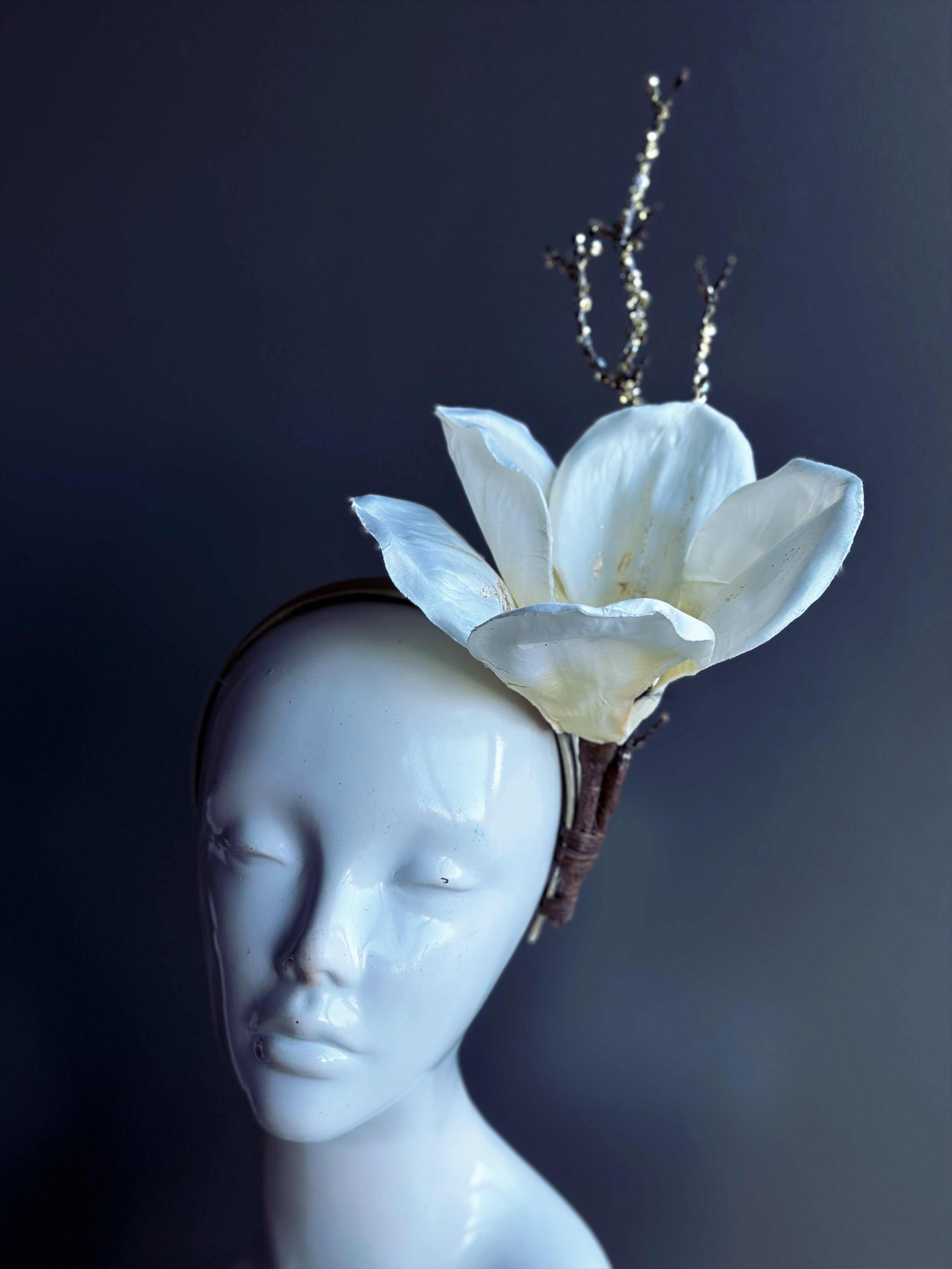 White flower headband with golden branches.