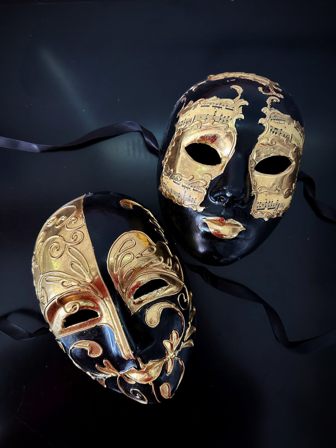 Black and gold couples masquerade mask set with Venetian baroque swirls and music note details, ideal for prom, Halloween, or masquerade ball.