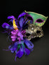 Coulpes masquerade masks in green, gold, and purple.